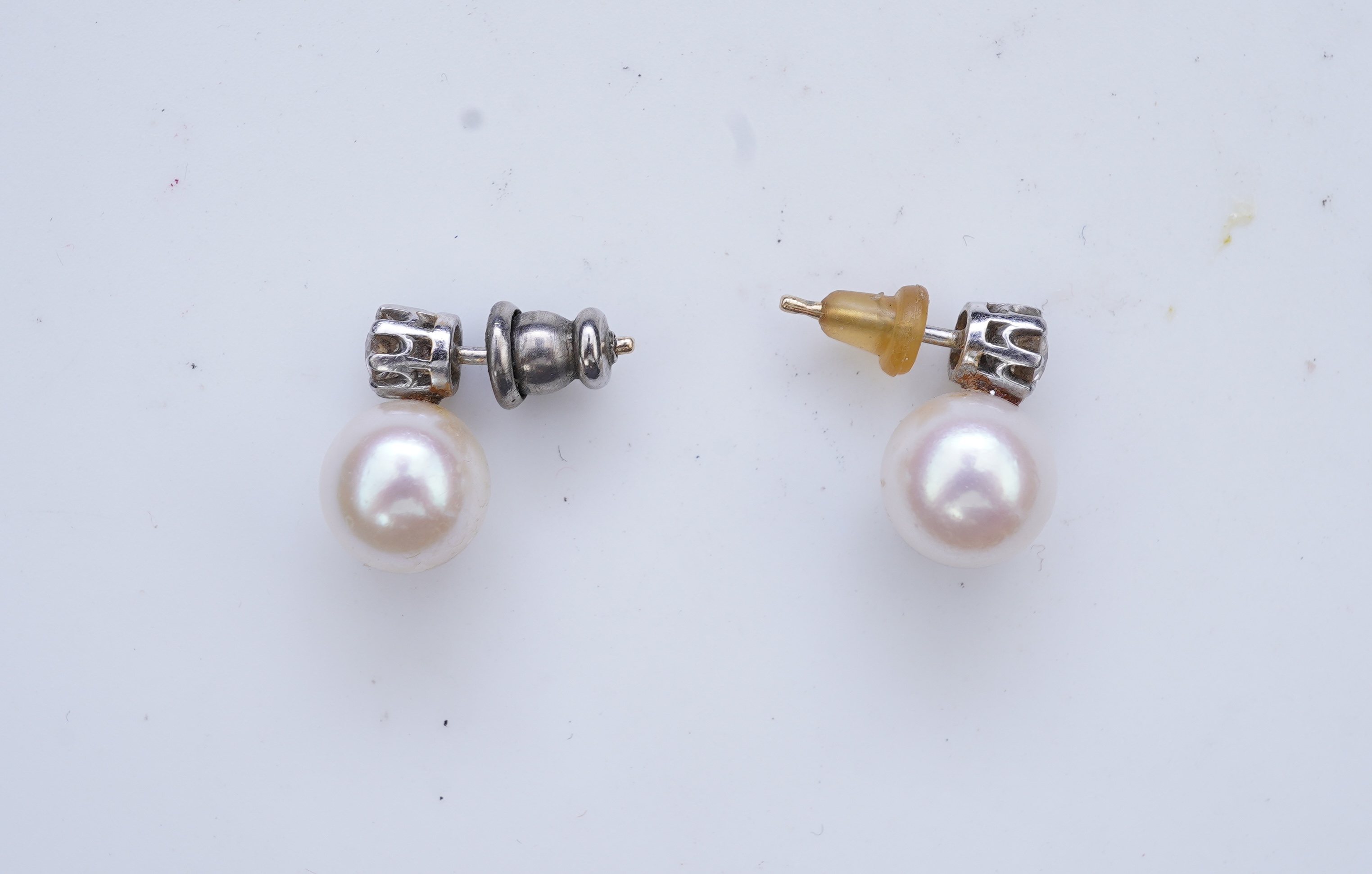 A pair of cultured pearl and diamond earrings